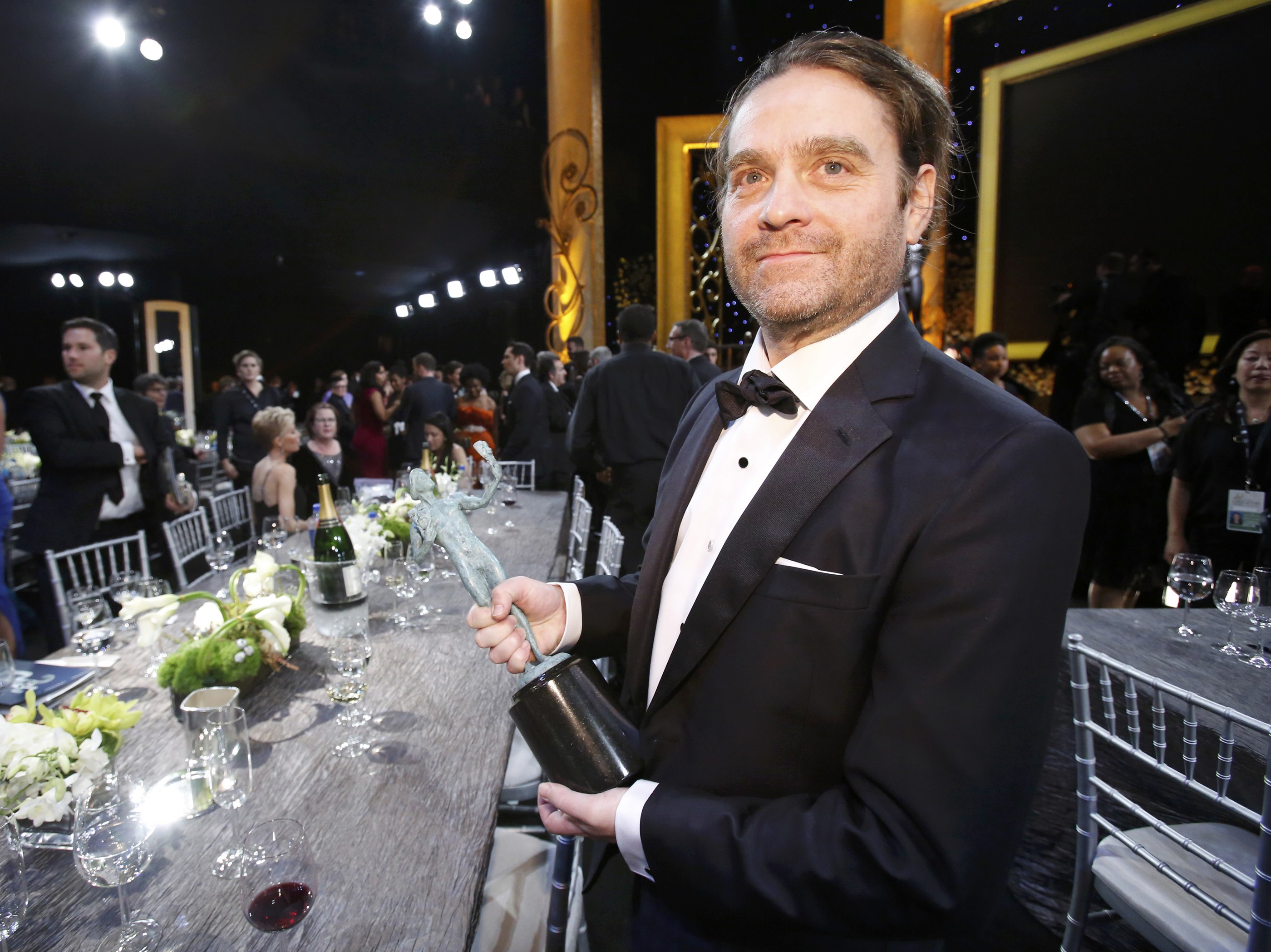 Zach Galifianakis poses with his award for Outstanding Performance by a Cast in a Motion Picture  for his work in "Birdman" at the 21st annual Screen Actors Guild Awards in Los Angeles