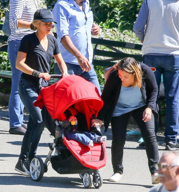 EXCLUSIVE: Shakira spotted trying to keep her balance while carrying her son Sasha and talking on her cellphone while they where in Central Park in New York City