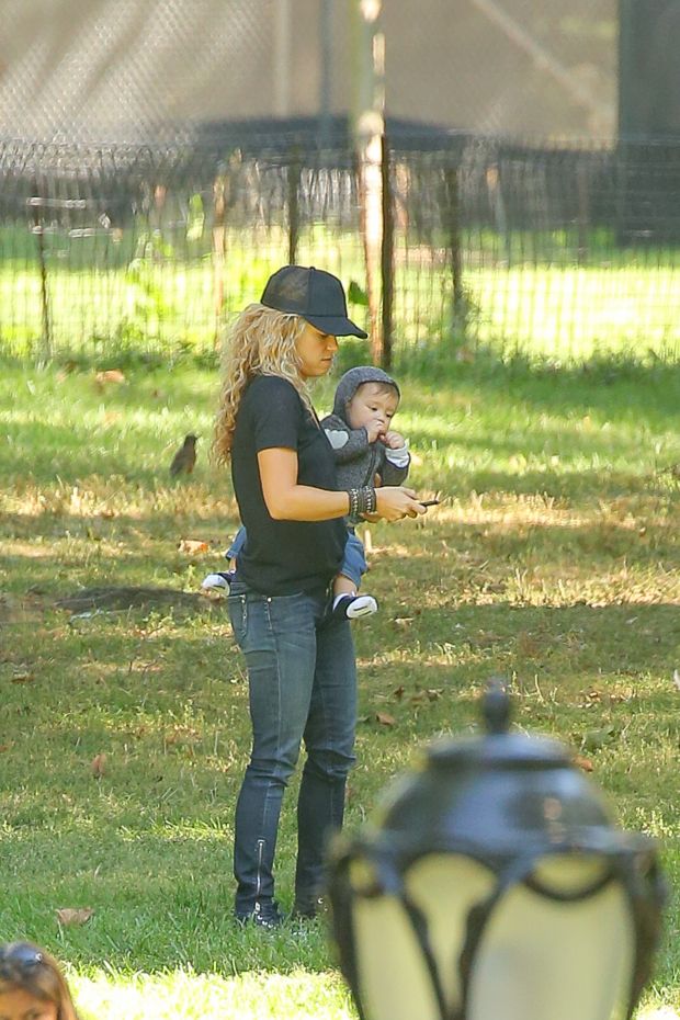 EXCLUSIVE: Shakira spotted trying to keep her balance while carrying her son Sasha and talking on her cellphone while they where in Central Park in New York City