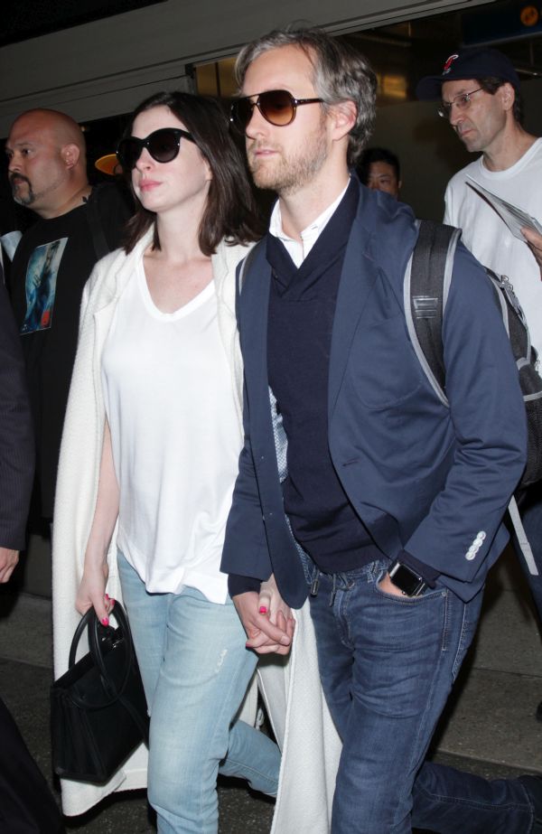 Anne Hathaway seen hand-in-hand with husband Adam Shulman returning to the USA at LAX airport