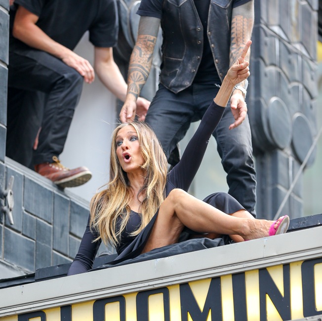 Sarah Jessica Parker spotted sitting on top of the Bloomingdale's sign while doing a photo shoot in New York City on May 11, 2015. Pictured: Sarah Jessica Parker Ref: SPL1023232 110515 Picture by: Felipe Ramales / Splash News Splash News and Pictures Los Angeles: 310-821-2666 New York: 212-619-2666 London: 870-934-2666 photodesk@splashnews.com 