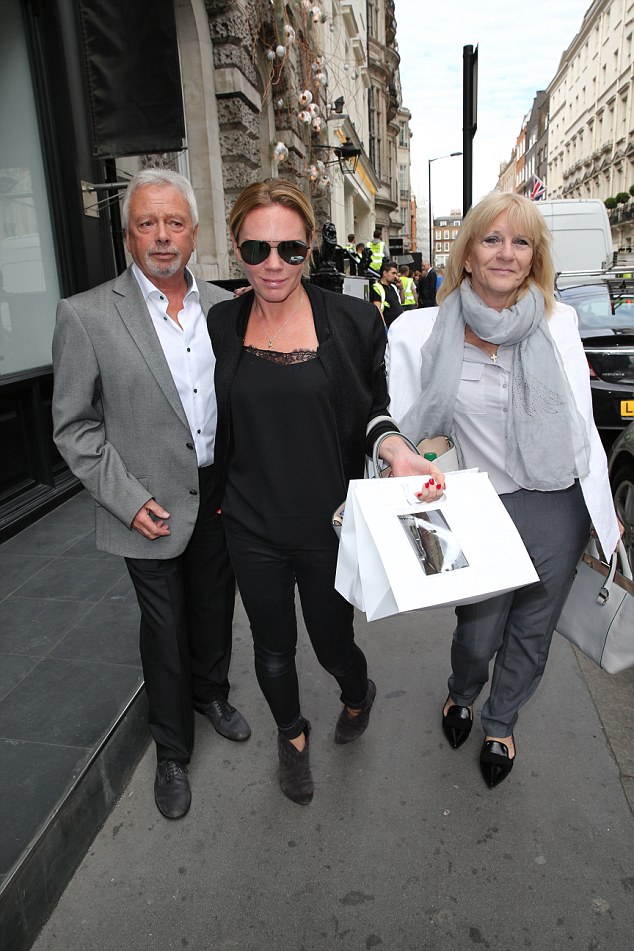 PICTURE - MARK LARGE ...25.09.14 Victoria Beckham's sister Louise Adams leaves her parents Tony and Sandra after visiting the Victoria Beckham store in Dover Street, London.