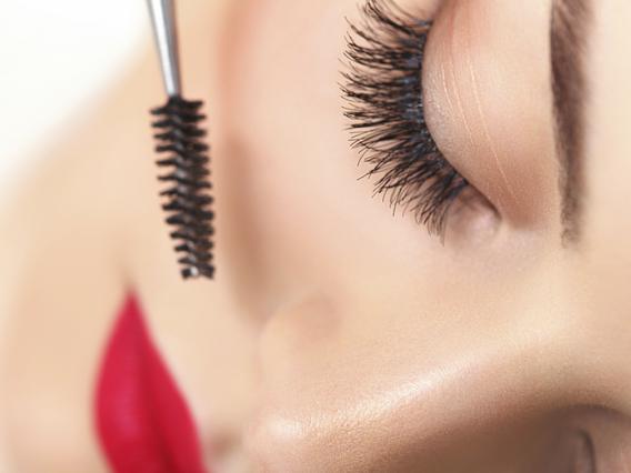 Woman eye with beautiful makeup and long eyelashes. Mascara Brush. High quality image.
