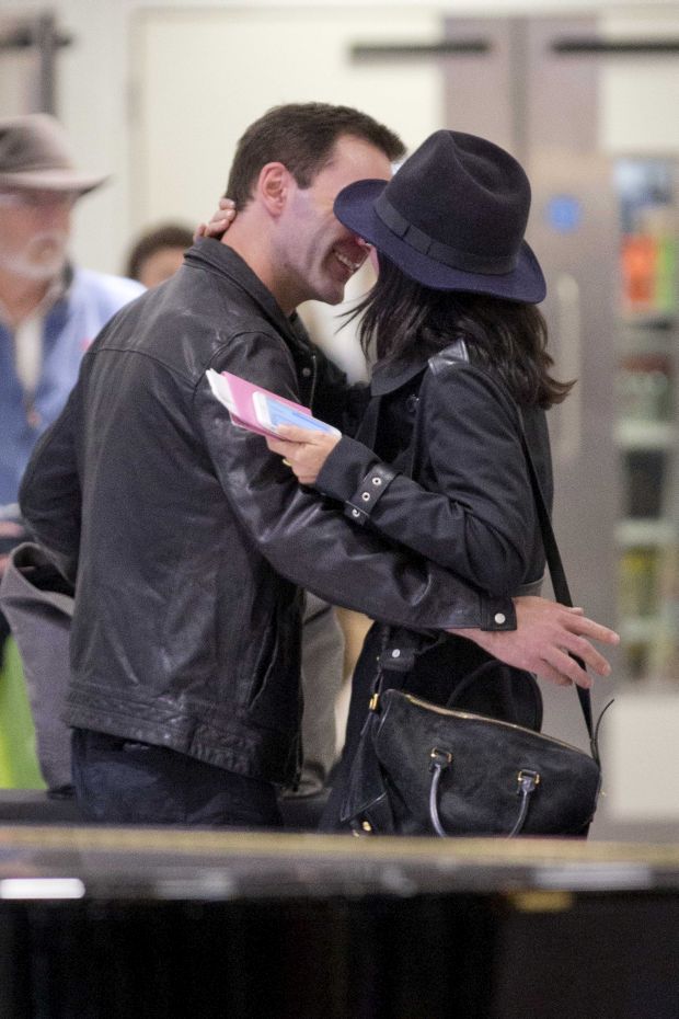 EXCLUSIVE: Courteney Cox and Johnny McDaid are back on as the pair kiss at Heathrow airport this afternoon.