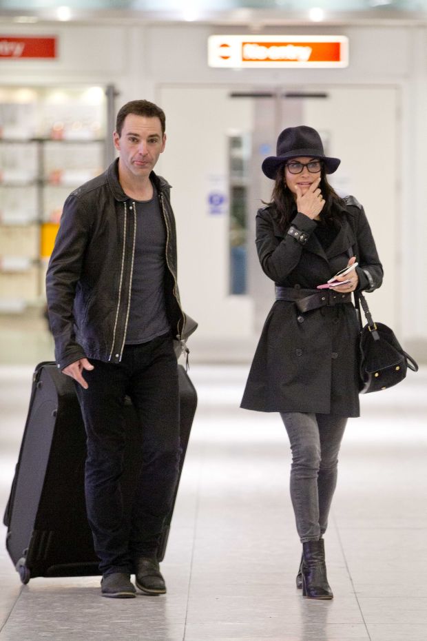 EXCLUSIVE: Courteney Cox and Johnny McDaid are back on as the pair kiss at Heathrow airport this afternoon.