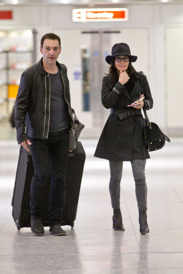 EXCLUSIVE: Courteney Cox and Johnny McDaid are back on as the pair kiss at Heathrow airport this afternoon.