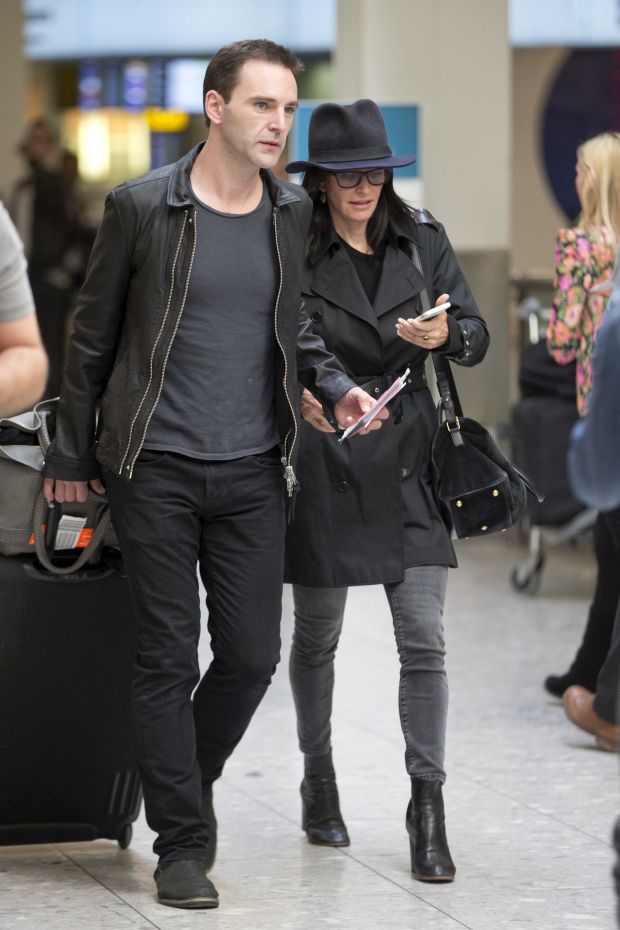 EXCLUSIVE: Courteney Cox and Johnny McDaid are back on as the pair kiss at Heathrow airport this afternoon.