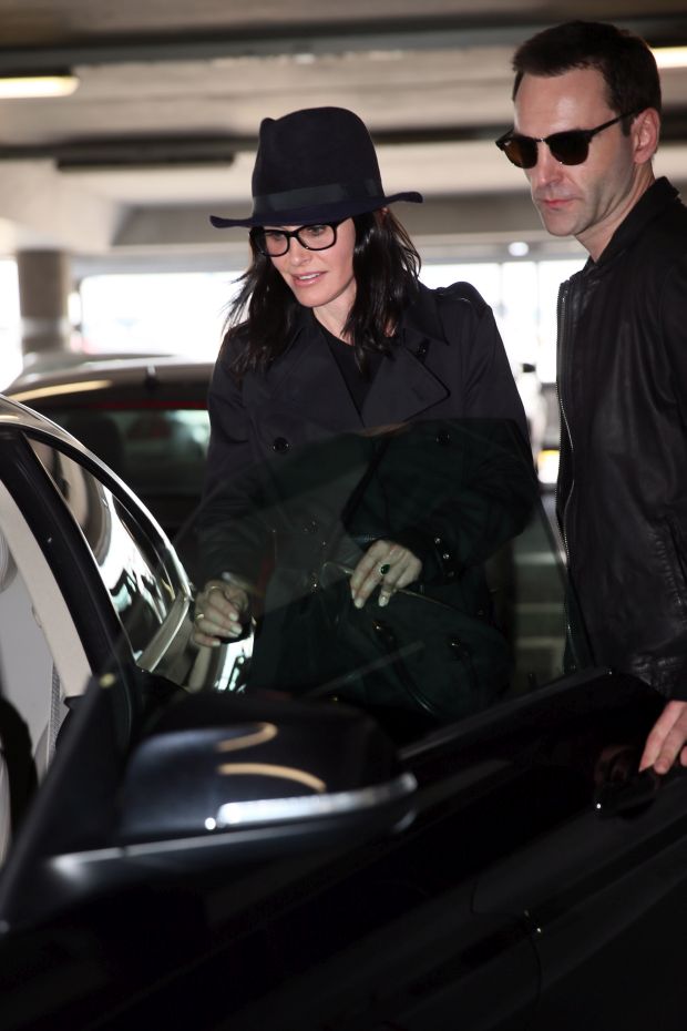 EXCLUSIVE: Courteney Cox and Johnny McDaid are back on as the pair kiss at Heathrow airport this afternoon.