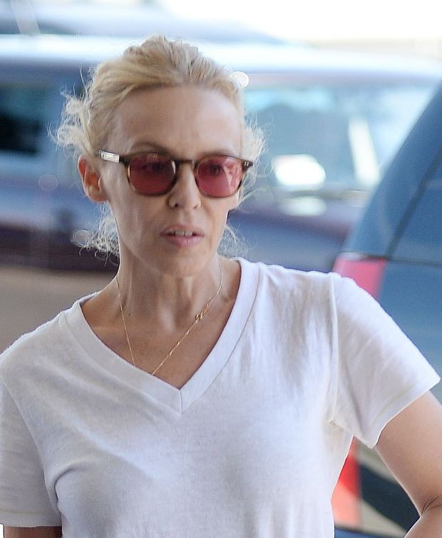EXCLUSIVE: Romantic couple Kylie Minogue and fiancι Joshua Sasse arrive at LAX Airport