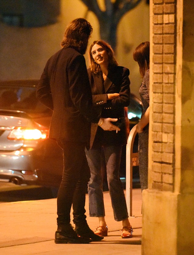 EXCLUSIVE: Alexa Chung and American singer & songwriter Joshua Tillman look to enjoy each others company outside jones bar in Los Angeles. Just before the pair were seen heading off in the musicians jaguar, Alexa cozied up to Joshua on the street.