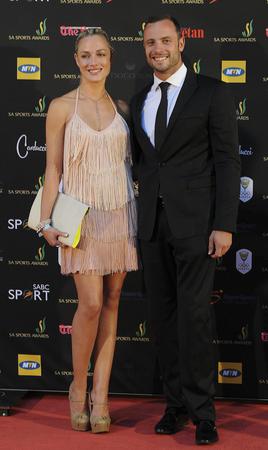 epa03584776 A picture made available on 15 February 2013 shows South African paralympic and Olympic sprinter, Oscar Pistorius (R) posing with his girlfriend, model Reeva Steenkamp (L) at the South African sports awards ceremony in Johannesburg 04 November 2012.  Pistorius was arrested for the fatal shooting of his girlfriend Reeva Steenkamp at his Pretoria home in South Africa 14 February 2013. The circumstances around the shooting are still unclear. He will make an appearance in Pretoria court 15 February 2013.  EPA/FRENNIE SHIVAMBU