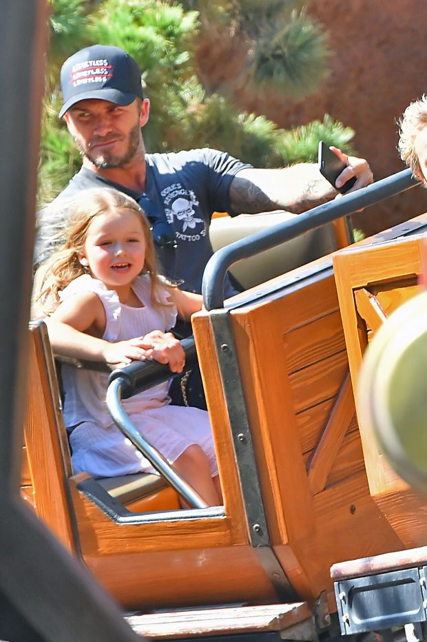 EXCLUSIVE: David Beckham takes a selfie with his daughter Harper as they ride Big Thunder Mountain Railroad at Disneyland