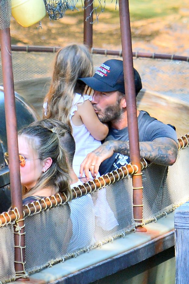 EXCLUSIVE: David Beckham shares a sweet moment with his daughter Harper as he and his family enjoy a ride on the Jungle Cruise at Disneyland (Blurred)