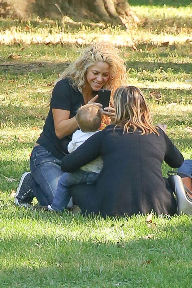 EXCLUSIVE: Shakira spotted trying to keep her balance while carrying her son Sasha and talking on her cellphone while they where in Central Park in New York City