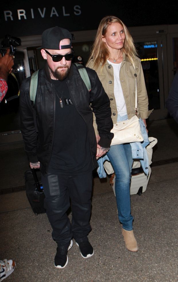 Cameron Diaz and Benji madden arriving on a flight at LAX airport ,in Los Angeles, CA Pictured: Cameron Diaz , Benji maddenRef: SPL1113355  310815  Picture by: Roshan PereraSplash News and PicturesLos Angeles:
