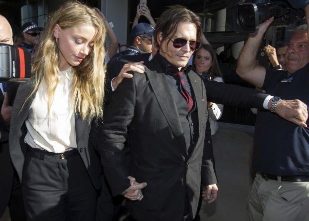 Amber Heard and Johnny Depp leave Southport Magistrates Court after signing a deal for dog smuggling charges laid against them.