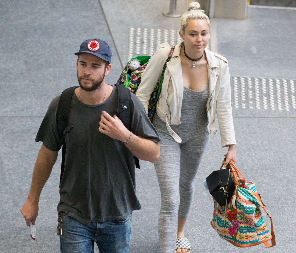 Liam Hemsworth and Miley Cyrus depart Brisbane airport. Liam Hemsworth and Miley Cyrus are seen departing Brisbane airport after spending a week in Byron Bay. Miley wore a grey one piece jumpsuit as she and Liam were escorted from a private entrance into customs. Pictured: Miley Cyrus and Liam Hemsworth Ref: SPL1272805  020516   Picture by: Splash News Splash News and Pictures Los Angeles:310-821-2666 New York:212-619-2666 London:870-934-2666 photodesk@splashnews.com 