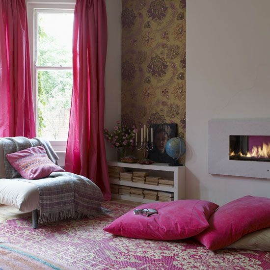Living room floral gold wallpaper alcove feature wall by designer Matthew Williamson pink rug floor cushions silk curtains lit fireplace real home L etc 02/2009 pub orig
